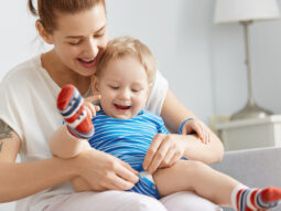 Mother and young child sharing a positive caregiving moment at home.